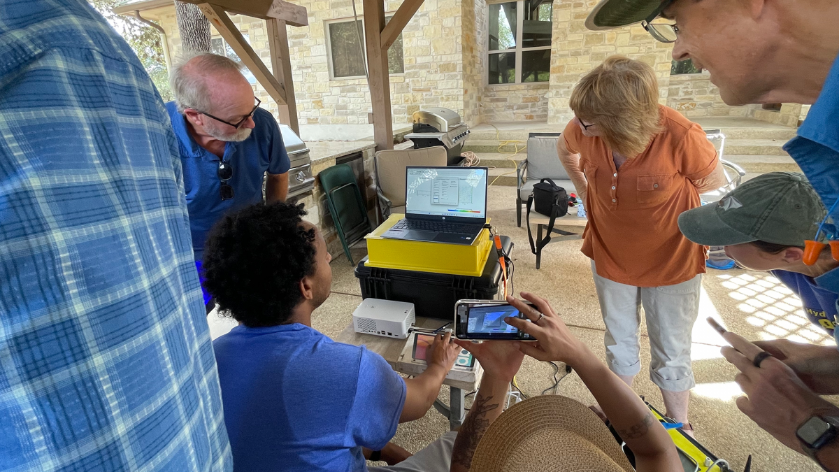 Participants reviewing resistivity data on a laptop