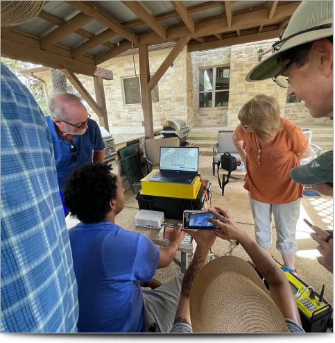 People looking at resistivity data on a laptop