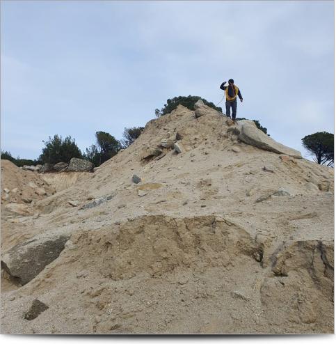 AGI Case History - Turkey Granite Mining Project - Survey worker with cables on a sandy hill