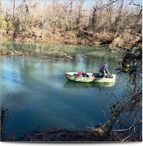 An Arkansas survey technician on a boat